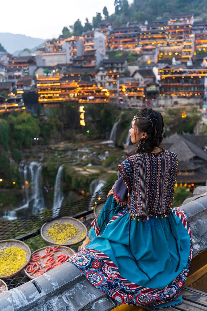 mujer de espaldas contemplando la ciudad de lijiang